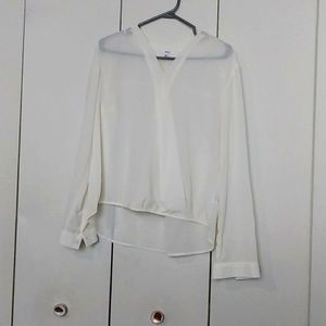 White see-through blouse with on with noticeable stains on it as indicated